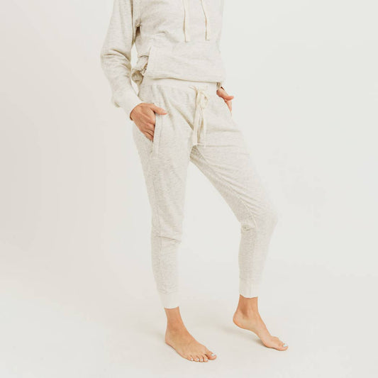Melange terry knit drawstring sweatpants with relaxed fit and side pockets, made from soft heathered fabric for loungewear or athleisure use